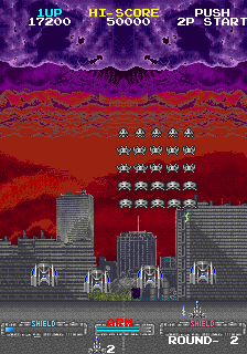 Majestic Twelve arcade screenshot with formations of aliens surrounding a large mechanical boss