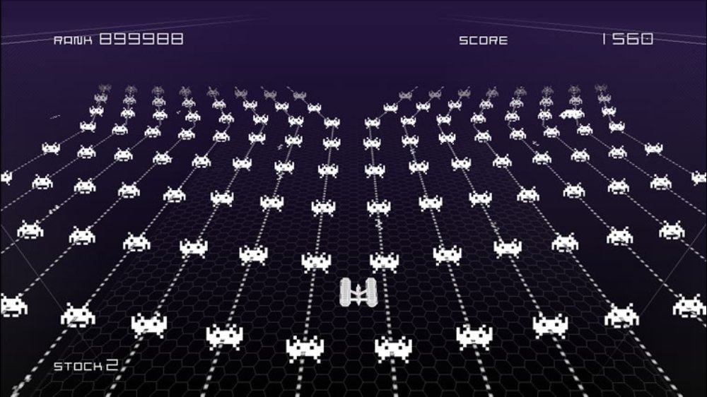 Space Invaders Infinity Gene screenshot with a white player ship facing intricate geometric enemy patterns
